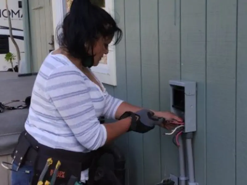 Licensed electrician wiring an exterior subpanel in Southside